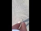 PIssing in a white bikini on the beach