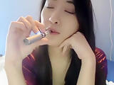 Asian model Meowsy smoking and sucking dildo