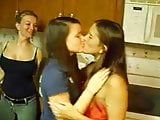 Lesbian girls kissing in front of her friends in a party